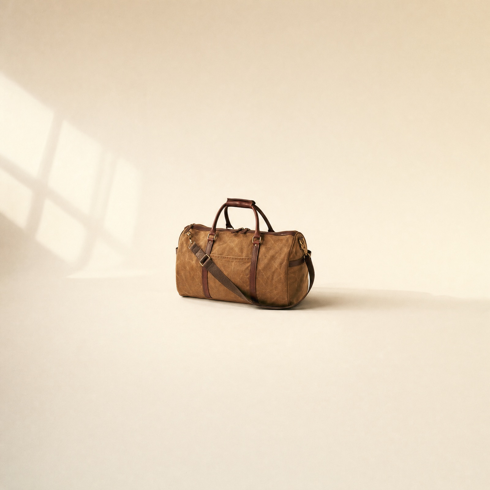 No. 06 Waxed Duffel — tan canvas with bridle leather straps and brass hardware